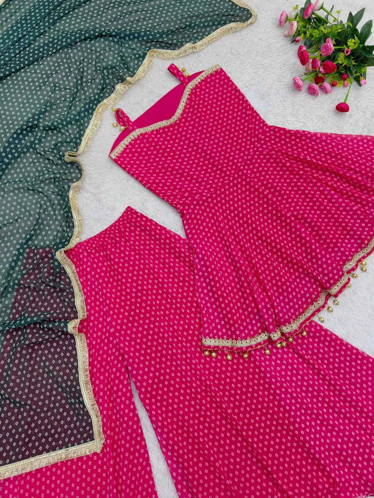 Flat lay of Pink Bandhej Print Suit showing ghungroo hem detail and dupatta