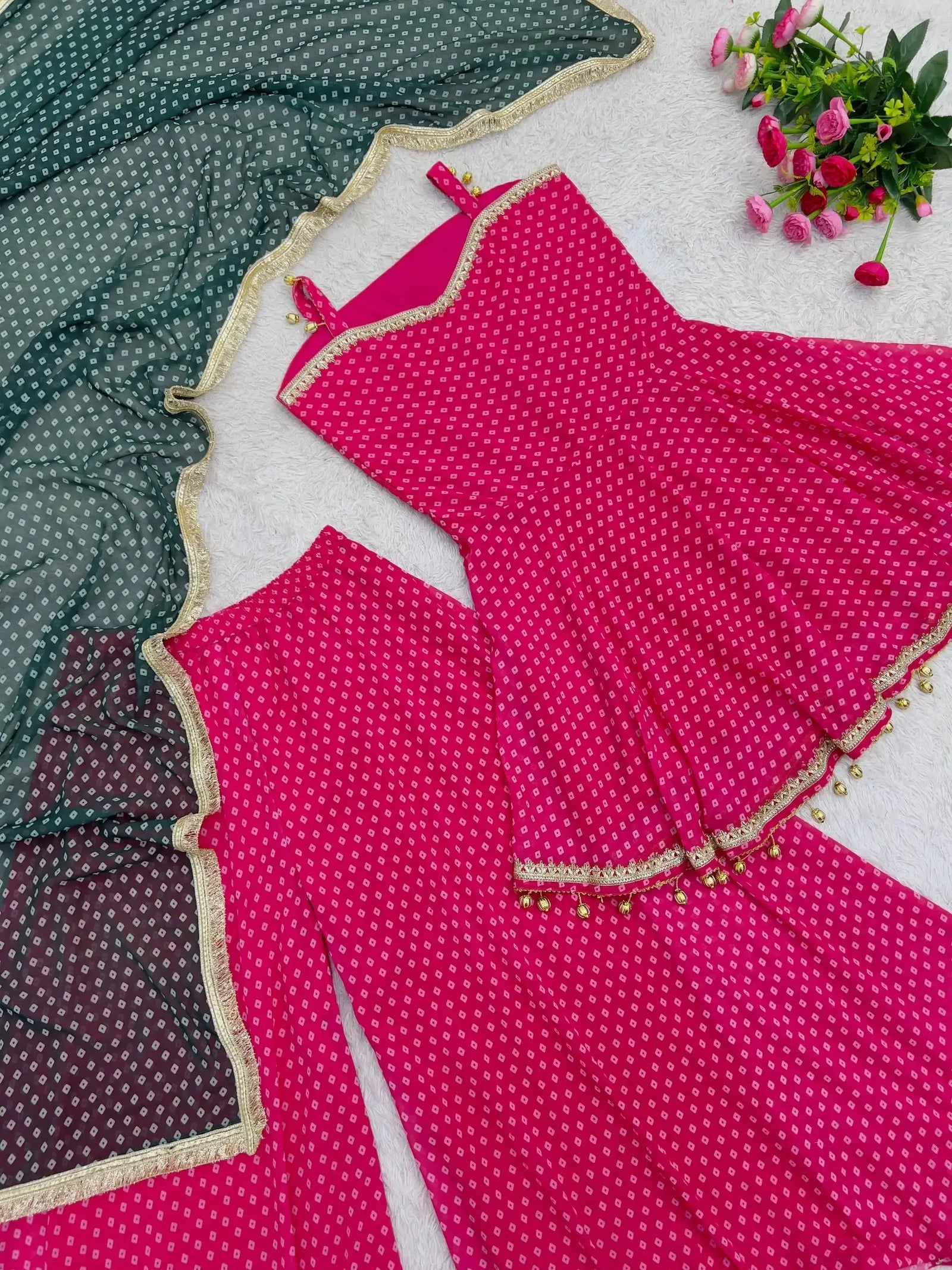 Flat lay of Pink Bandhej Print Suit showing ghungroo hem detail and dupatta