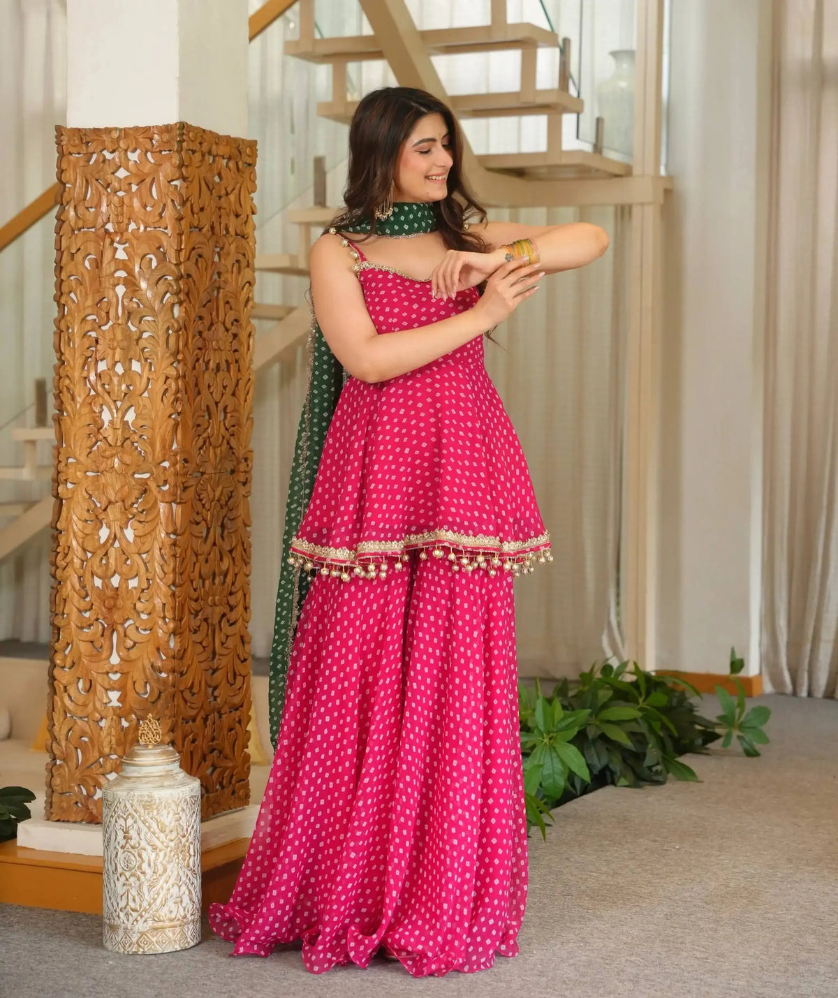 Pink Bandhej Print Suit front view model with gold bangles and green dupatta