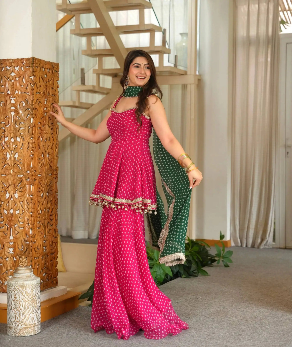 Pink Bandhej Print Suit side view model holding green dupatta