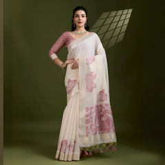 A woman models an elegant Beige Soft Muga Cotton Saree. The saree features large Kalamkari-style prints of peacocks and florals in a contrasting Dusty Rose Pink on the pallu. She wears a dusty pink elbow-sleeve blouse and accessorizes with a gold and pearl Kundan choker necklace, posing indoors.
