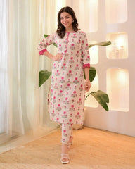 Woman wearing a floral dress in a bright room with plants