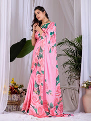 Woman wearing a pink floral saree with a white background