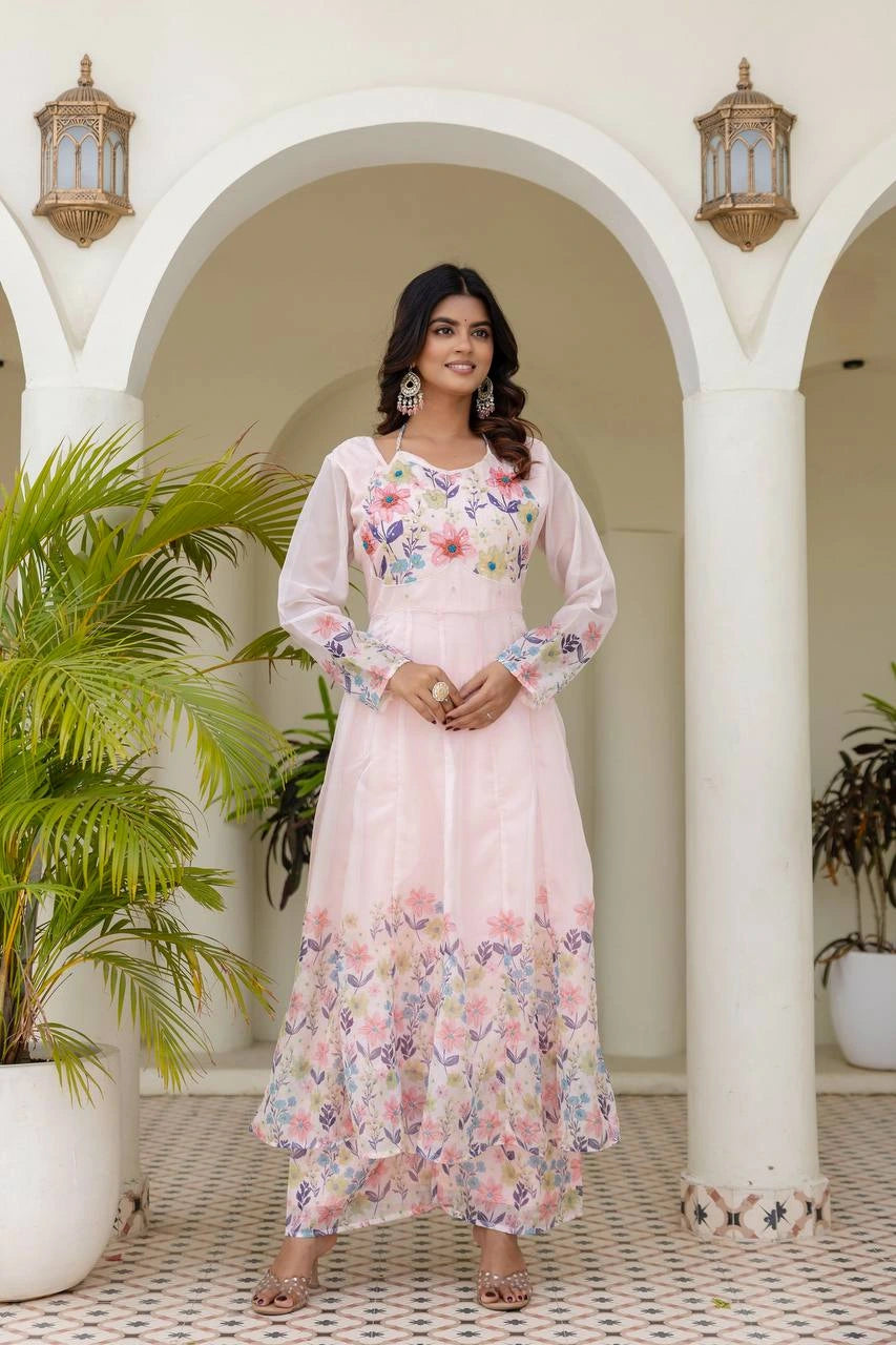 Elegant light pink floral printed Anarkali gown with full sleeves and graceful ethnic design.