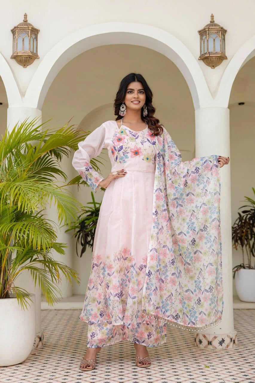 Traditional light pink floral Anarkali outfit with vibrant botanical print and flowing flare.