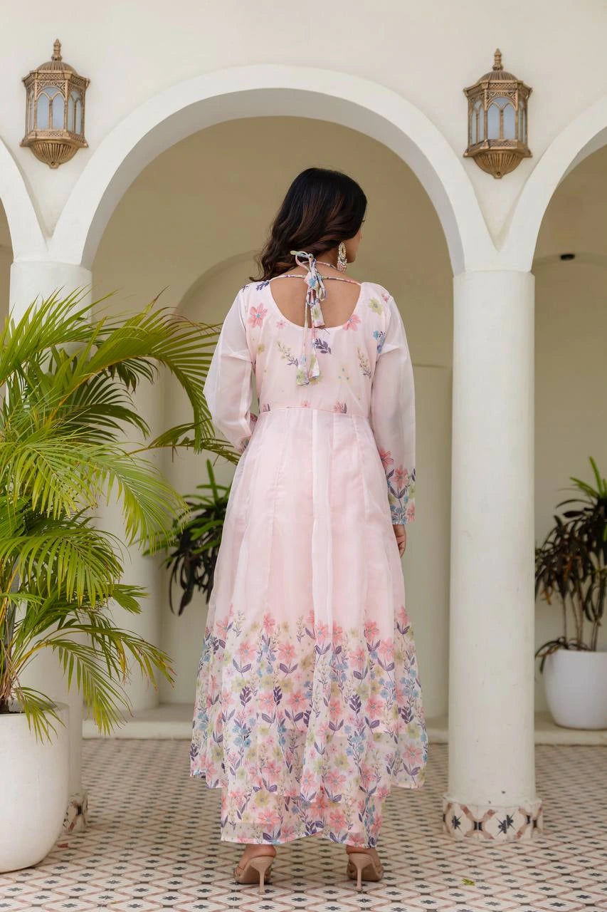 Beautiful light pink long Anarkali gown with colorful floral print for festive occasions.