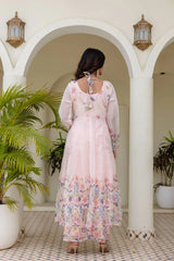 Beautiful light pink long Anarkali gown with colorful floral print for festive occasions.