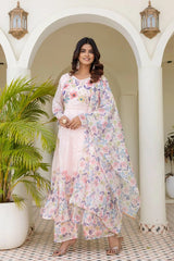 Women's pastel pink floral Anarkali dress featuring delicate flower prints and flowing silhouette.