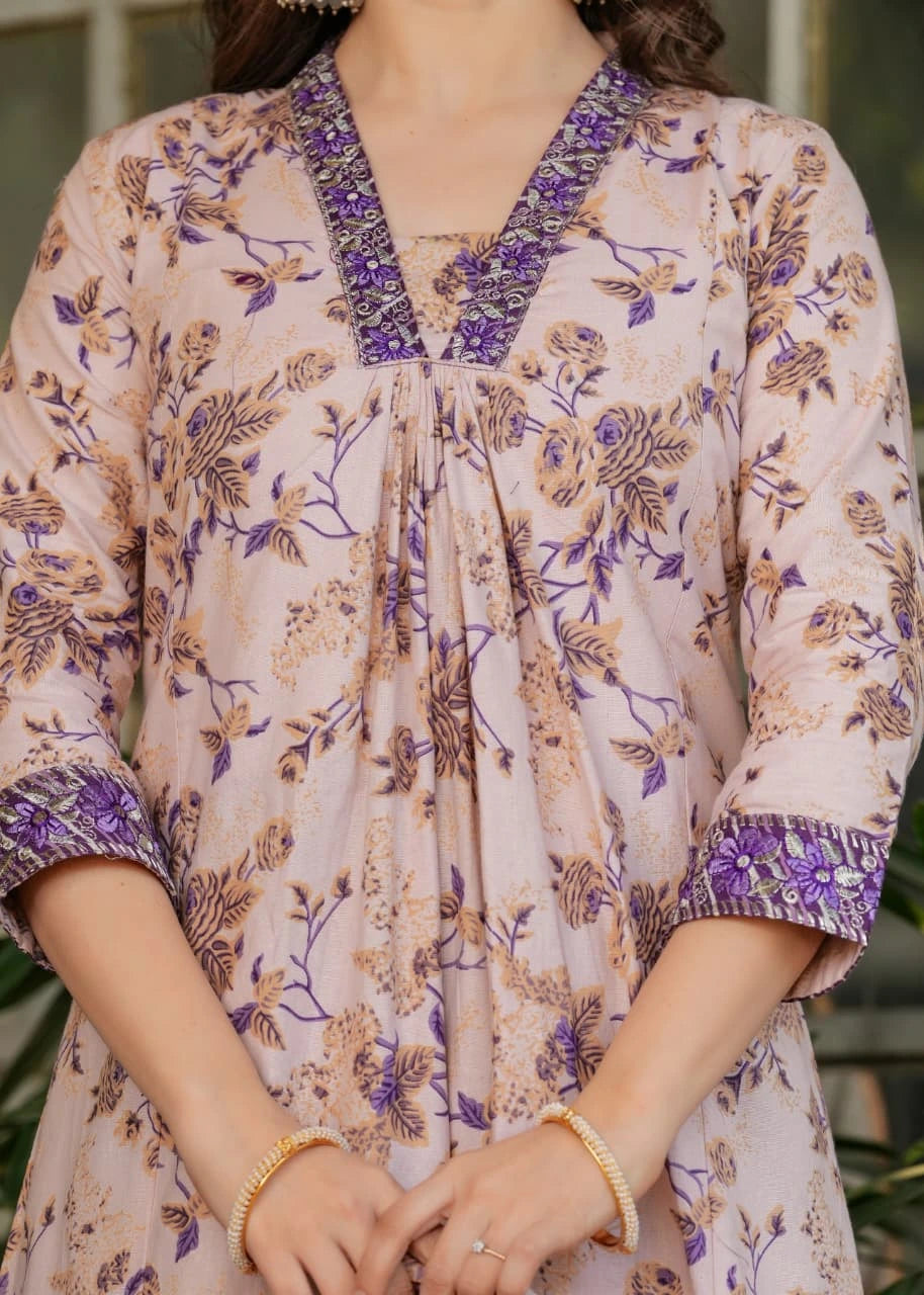 Close-up of a person wearing a floral dress with purple accents.