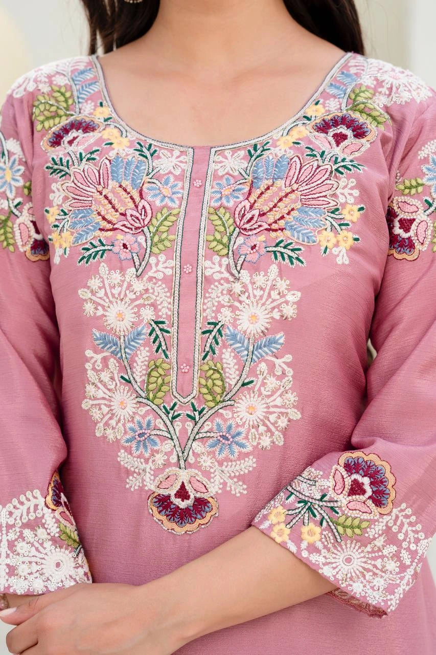 Close-up of a pink embroidered garment with floral patterns