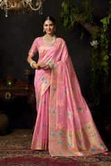 Woman wearing a pink saree with gold border in an elegant indoor setting