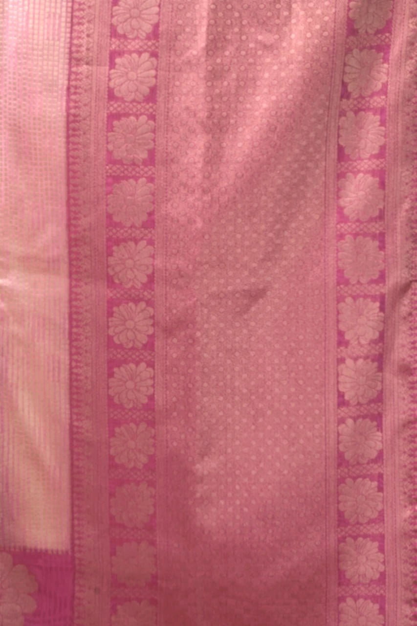 Close-up of a pink fabric with floral patterns and a border