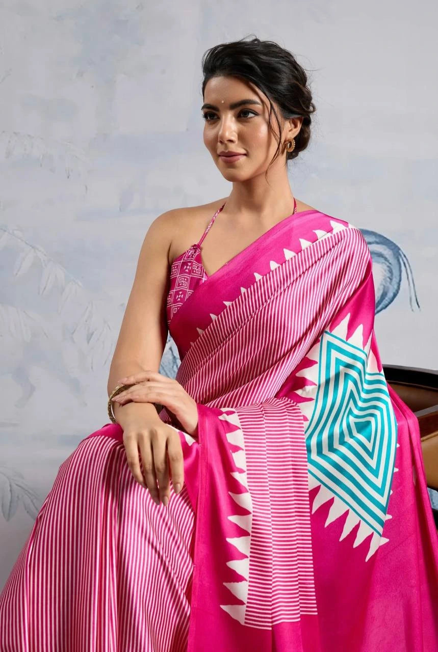 Woman wearing a pink saree with a geometric design on a light gray background