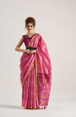Woman wearing a pink saree with a white background