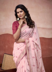 Woman wearing a pink saree with a red blouse against a beige background