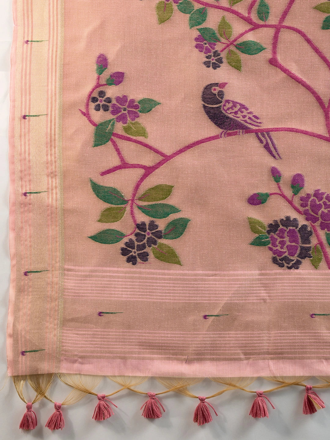 Pink fabric with embroidered bird and floral patterns on a white background