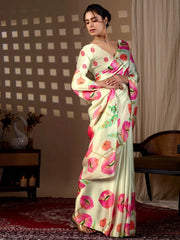 Woman wearing a floral saree with a checkered wall and curtain in the background
