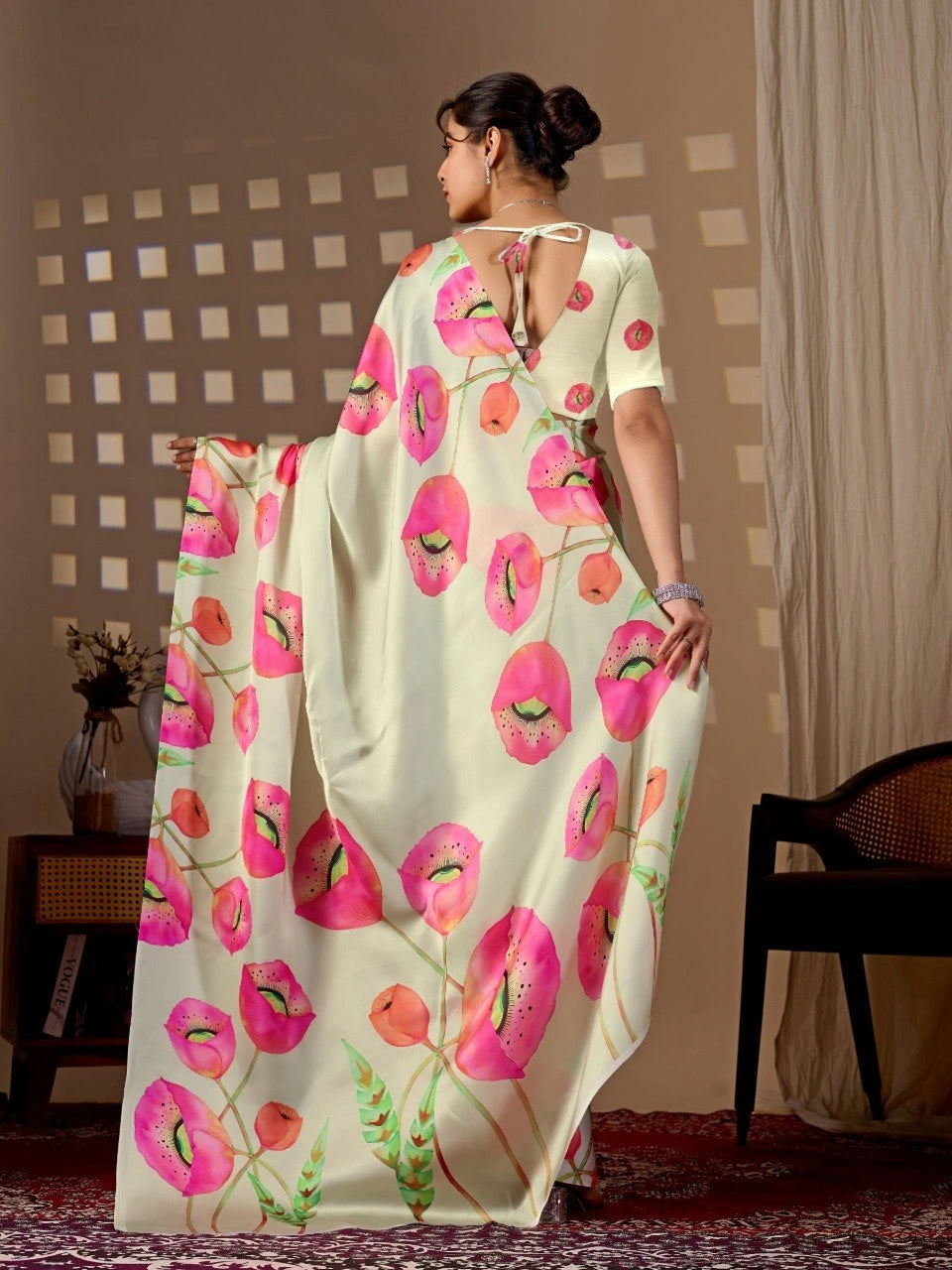 Woman wearing a floral saree with a neutral background