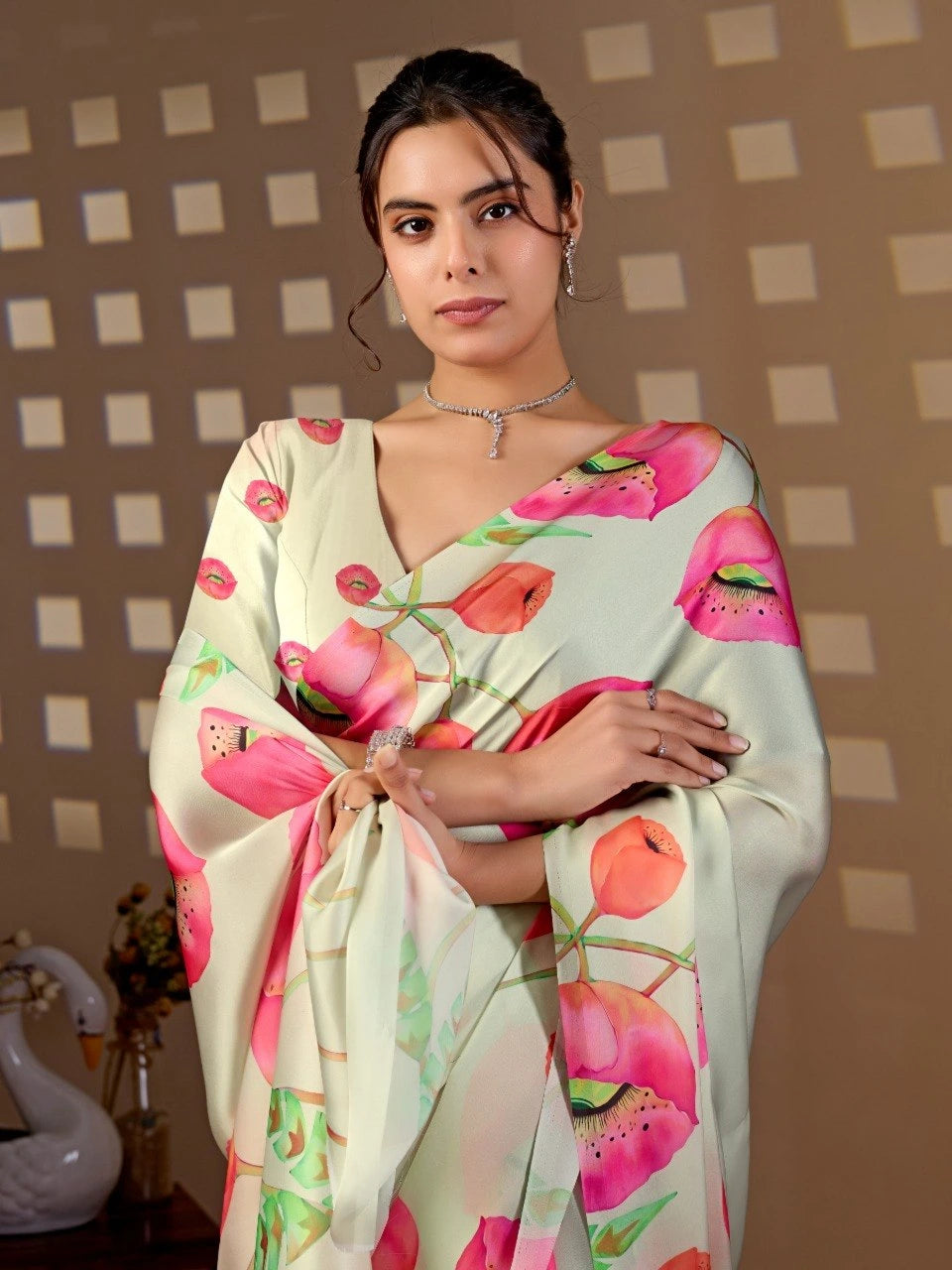 Woman wearing a floral saree with a checkered wall background