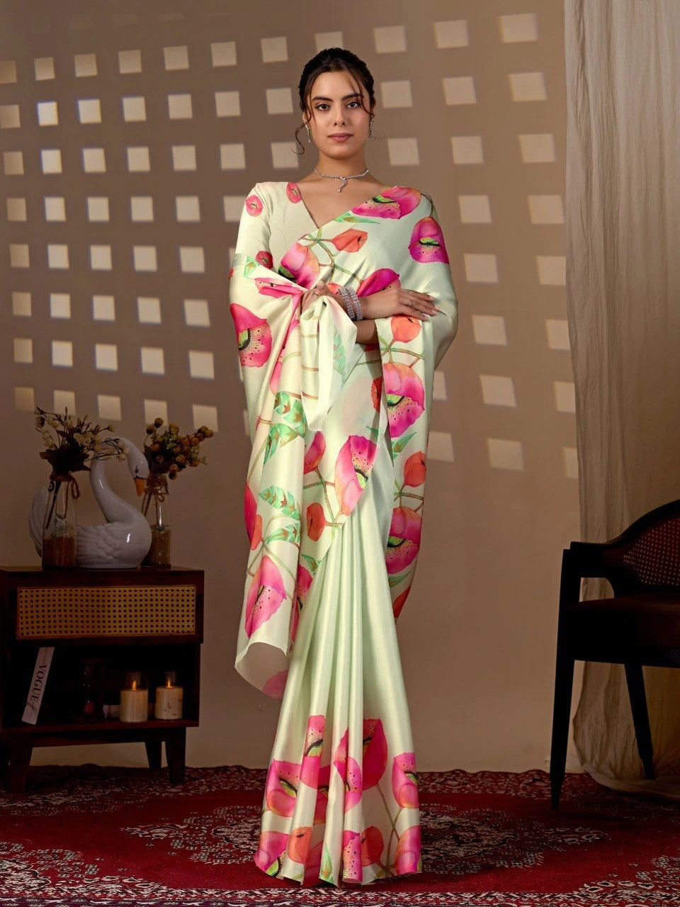 Woman wearing a floral saree in a room with decorative elements.