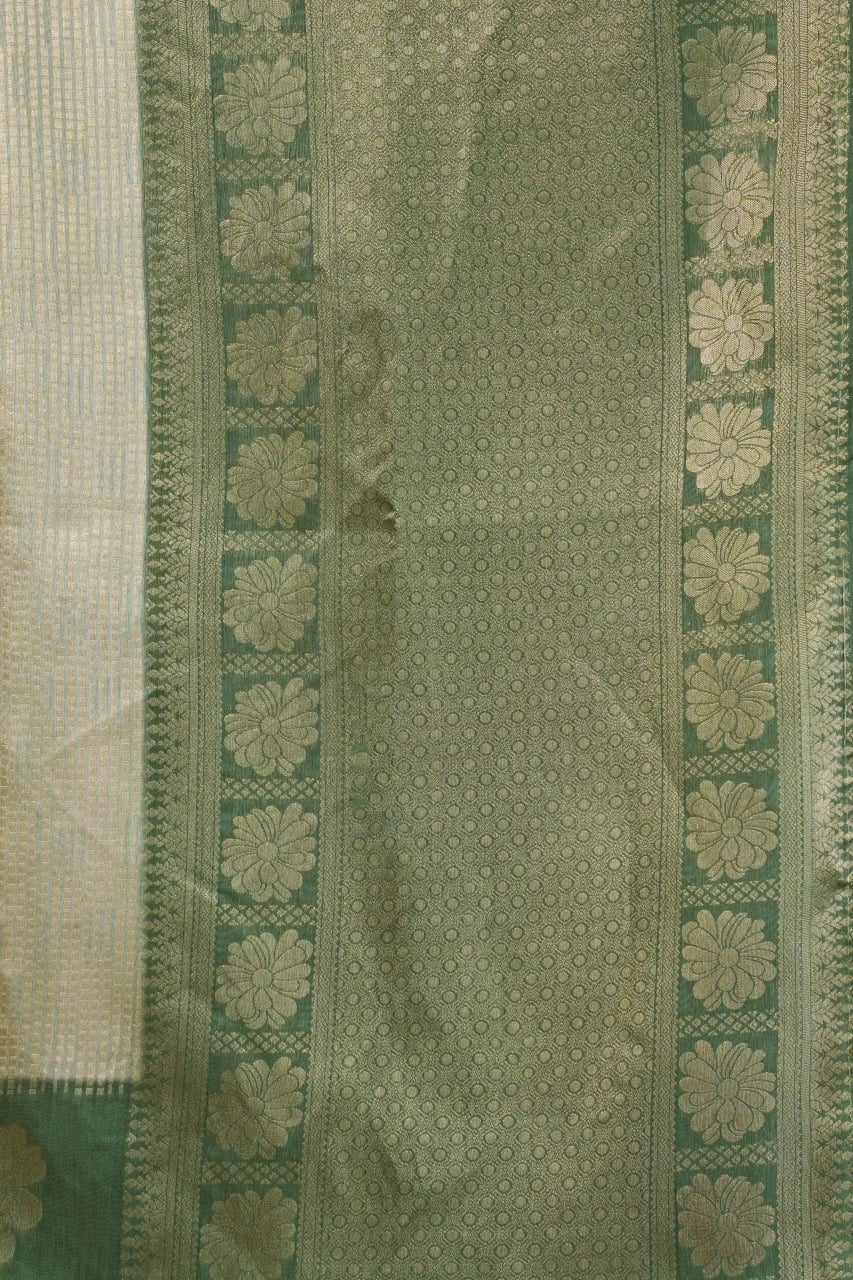 Green fabric with floral patterns and a border