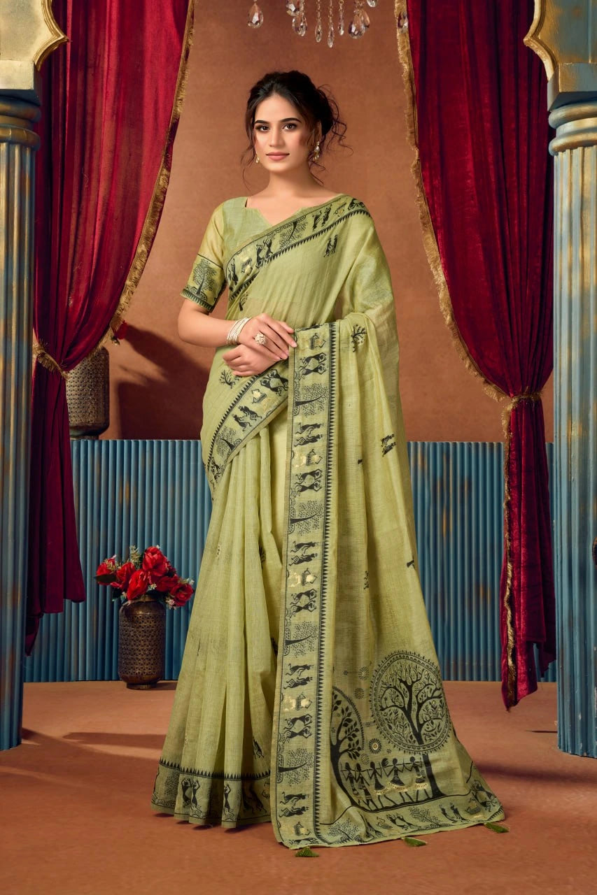 Woman wearing a green saree with a detailed border in a decorative setting.