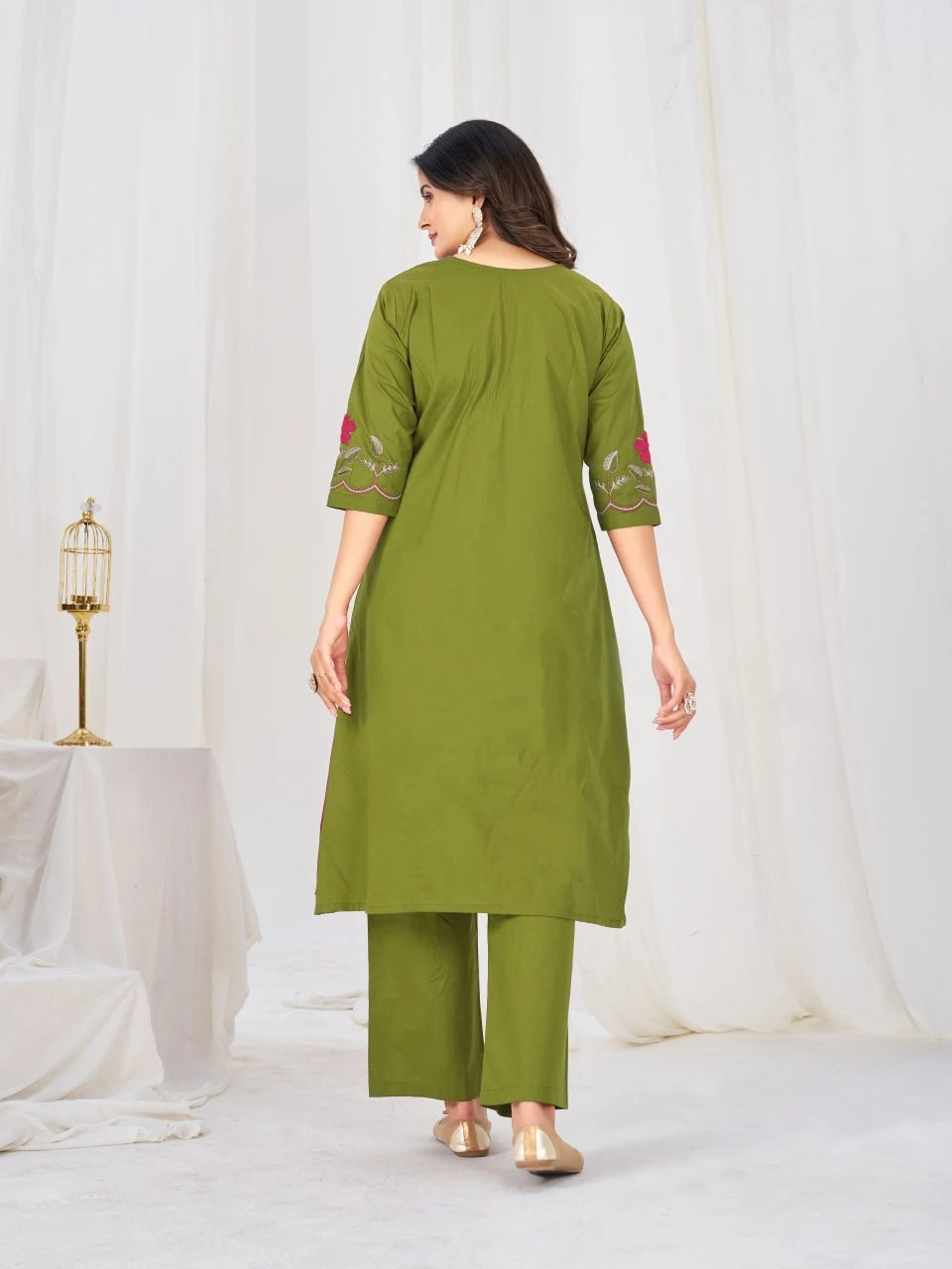 Stylish green ethnic ensemble adorned with colorful floral embroidery, perfect for festive celebrations, family gatherings, and special occasions.
