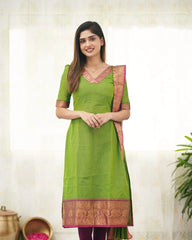 Woman wearing a green traditional outfit with a white background