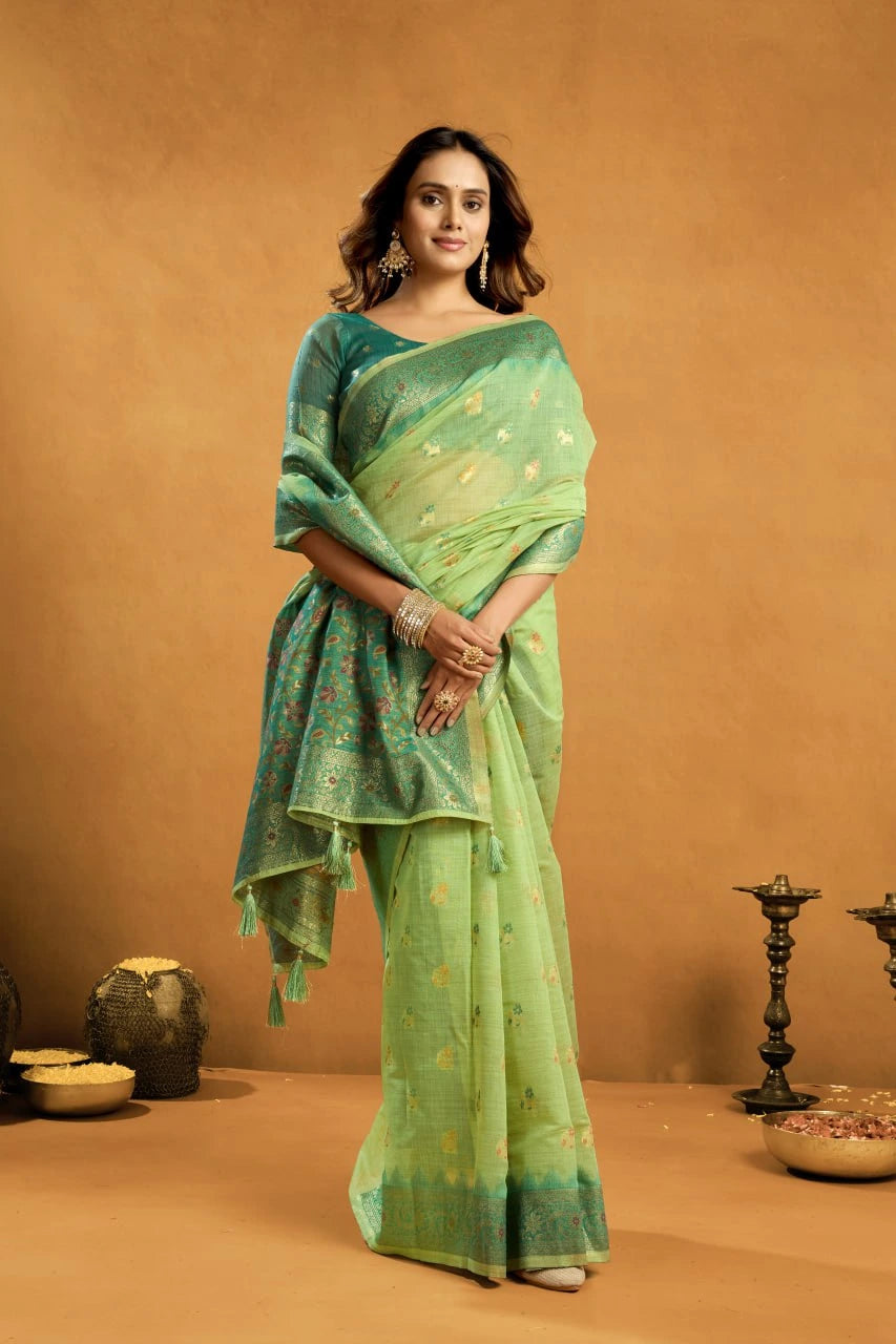 Woman wearing a green saree with a brown background