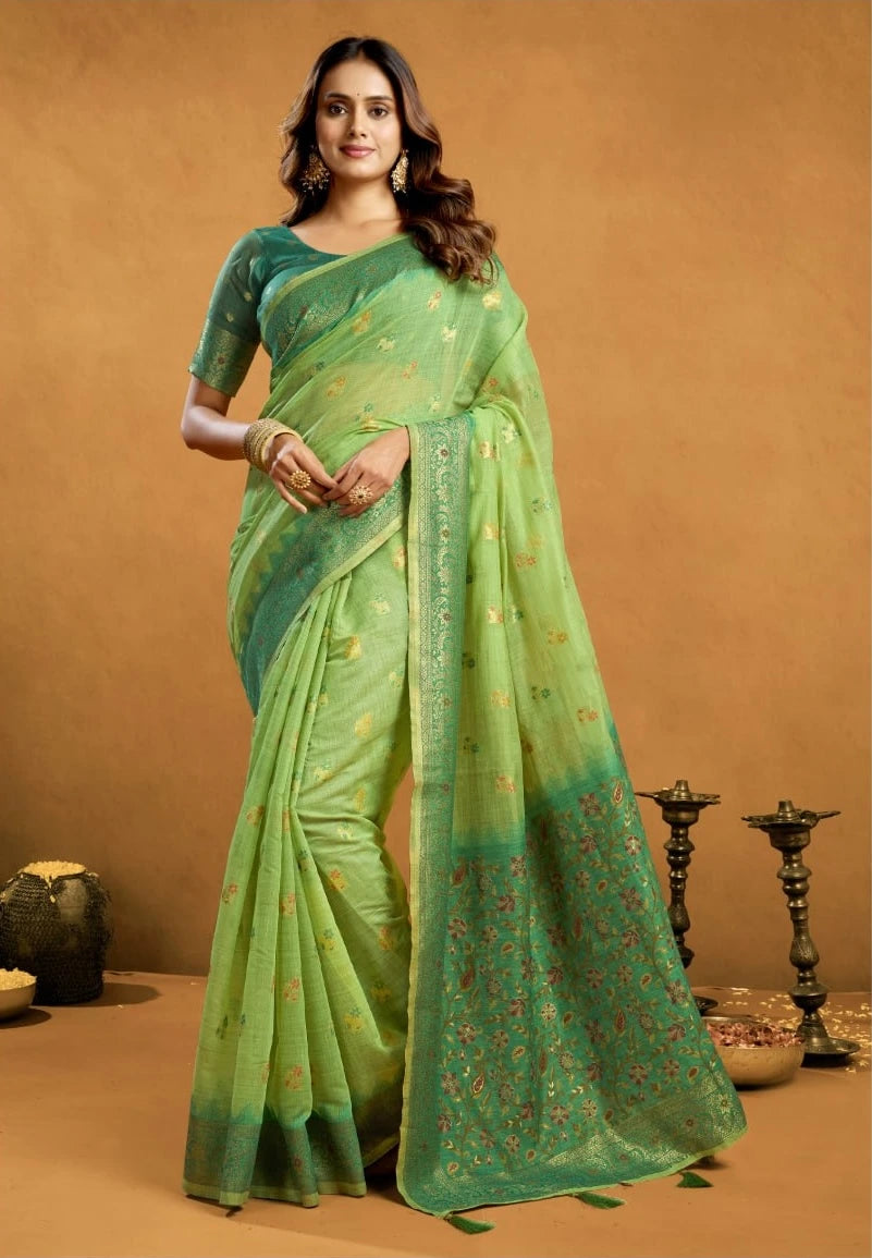 Woman wearing a green saree with a subtle pattern on a brown background