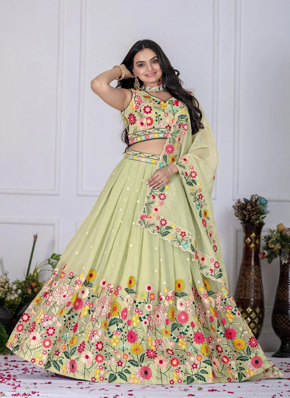 Woman wearing a light green floral lehenga with a white background