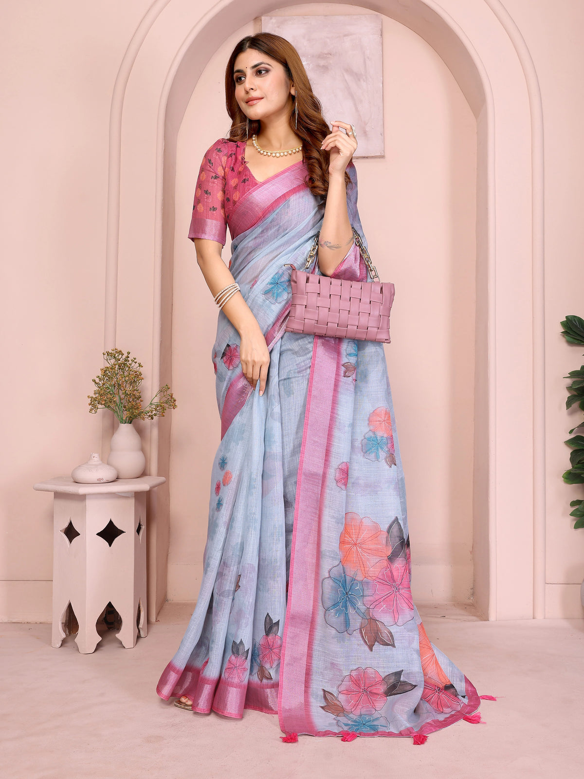 Powder Blue Digital Floral Print Saree on model – ink-outlined multicolor florals on powder blue linen cotton with pink tassels