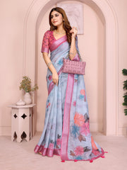 Powder Blue Digital Floral Print Saree on model – ink-outlined multicolor florals on powder blue linen cotton with pink tassels