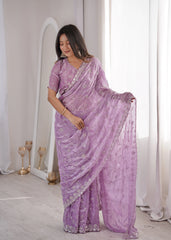 Woman wearing a purple saree with a white background