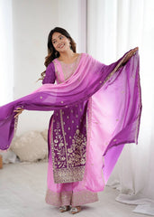 Woman holding a purple and pink embroidered dupatta against a white background