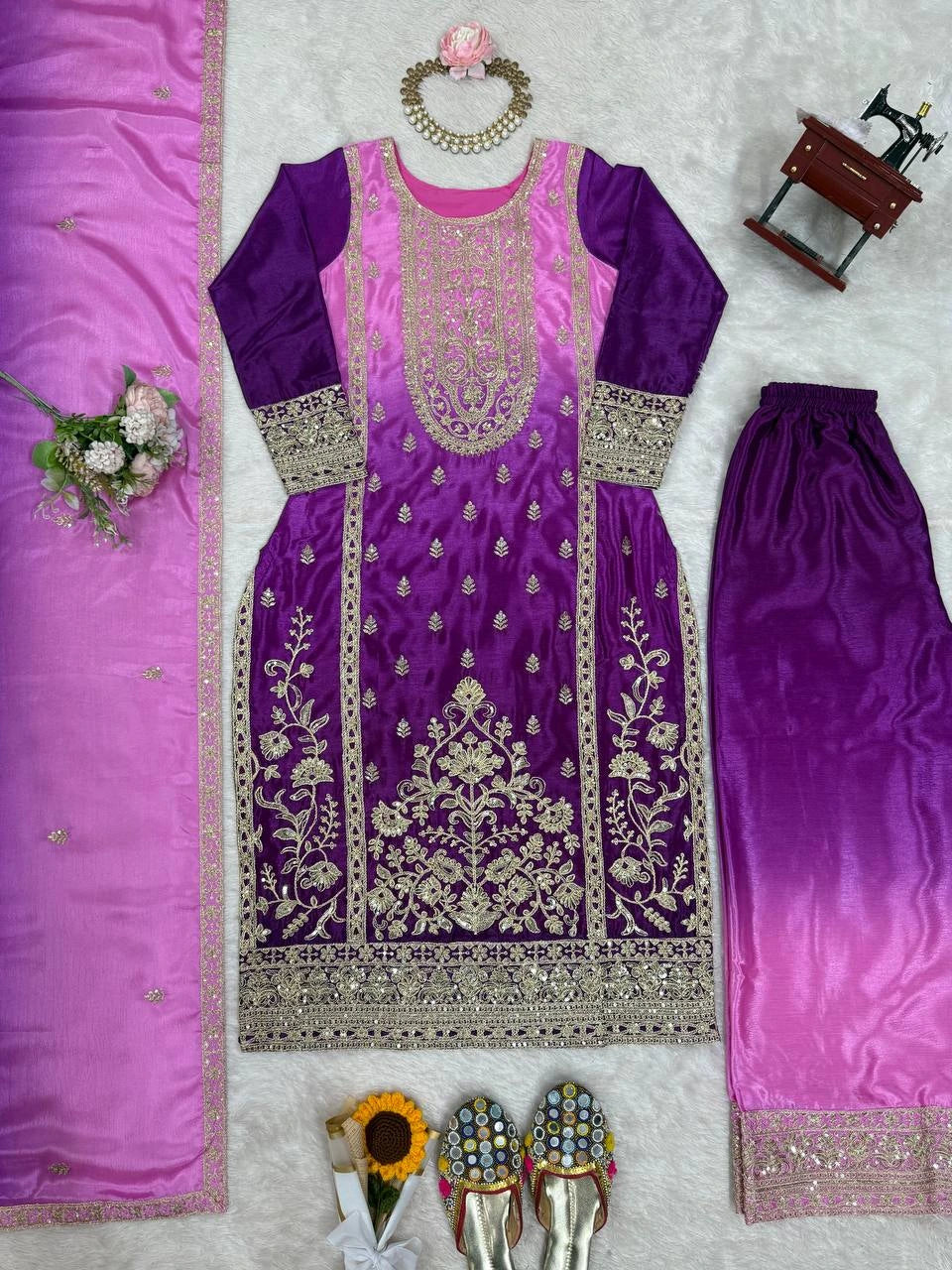 Purple embroidered outfit with matching dupatta on a light gray background