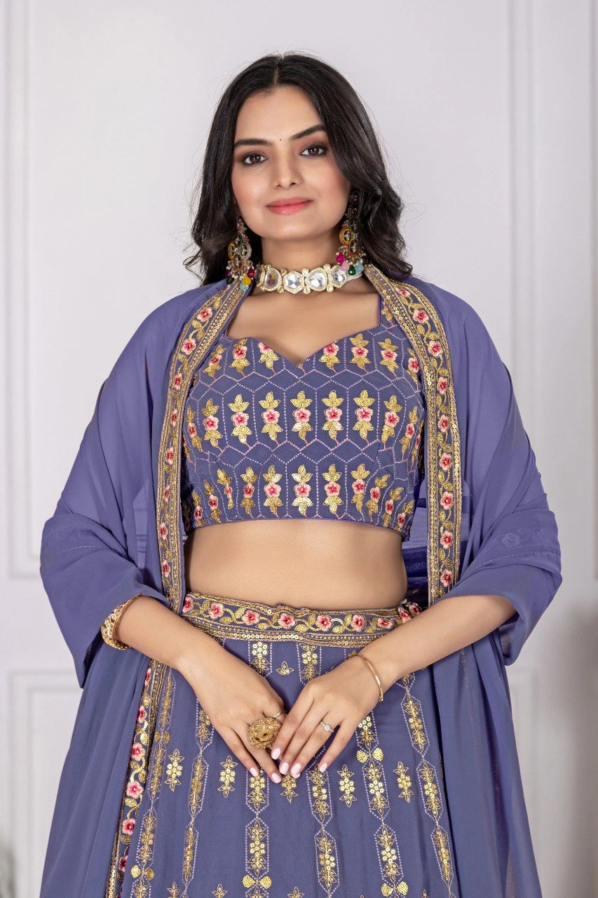 Woman wearing a traditional outfit with intricate patterns on a plain background