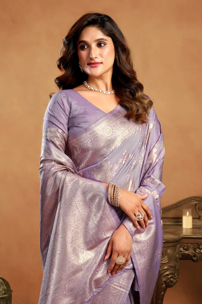 Woman wearing a purple saree with a brown background
