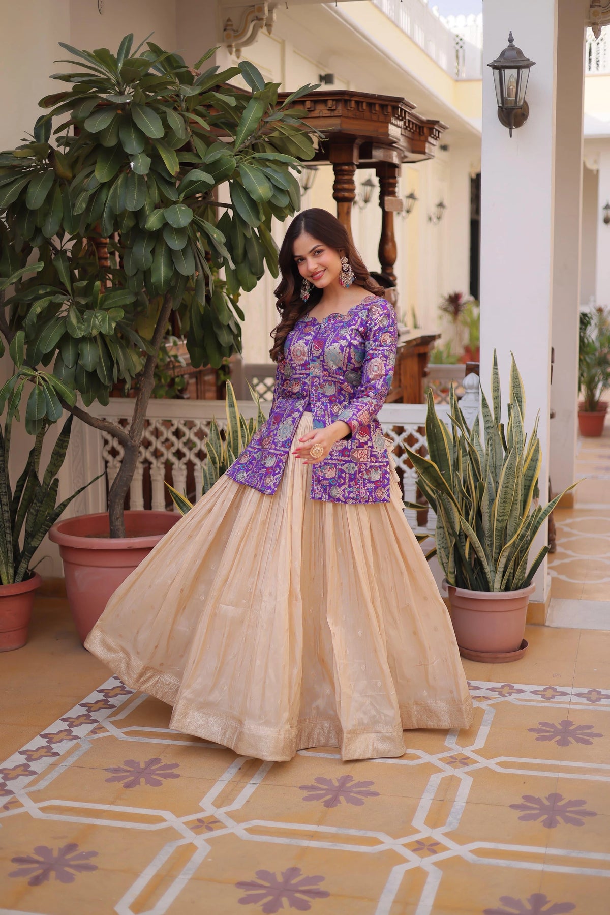 Woman in a traditional outfit standing in a decorated indoor setting with plants.