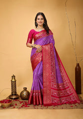 Woman wearing a purple and red saree with a beige background