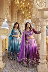 Two women in traditional outfits standing in an ornate indoor setting.