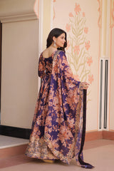 Woman wearing a floral dress in an indoor setting with decorative walls.