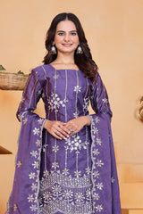 Woman wearing a purple traditional outfit with white patterns on a beige background
