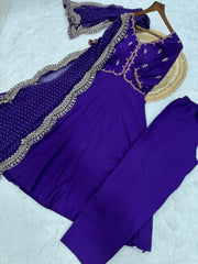Purple traditional outfit with embroidered details on a light gray background