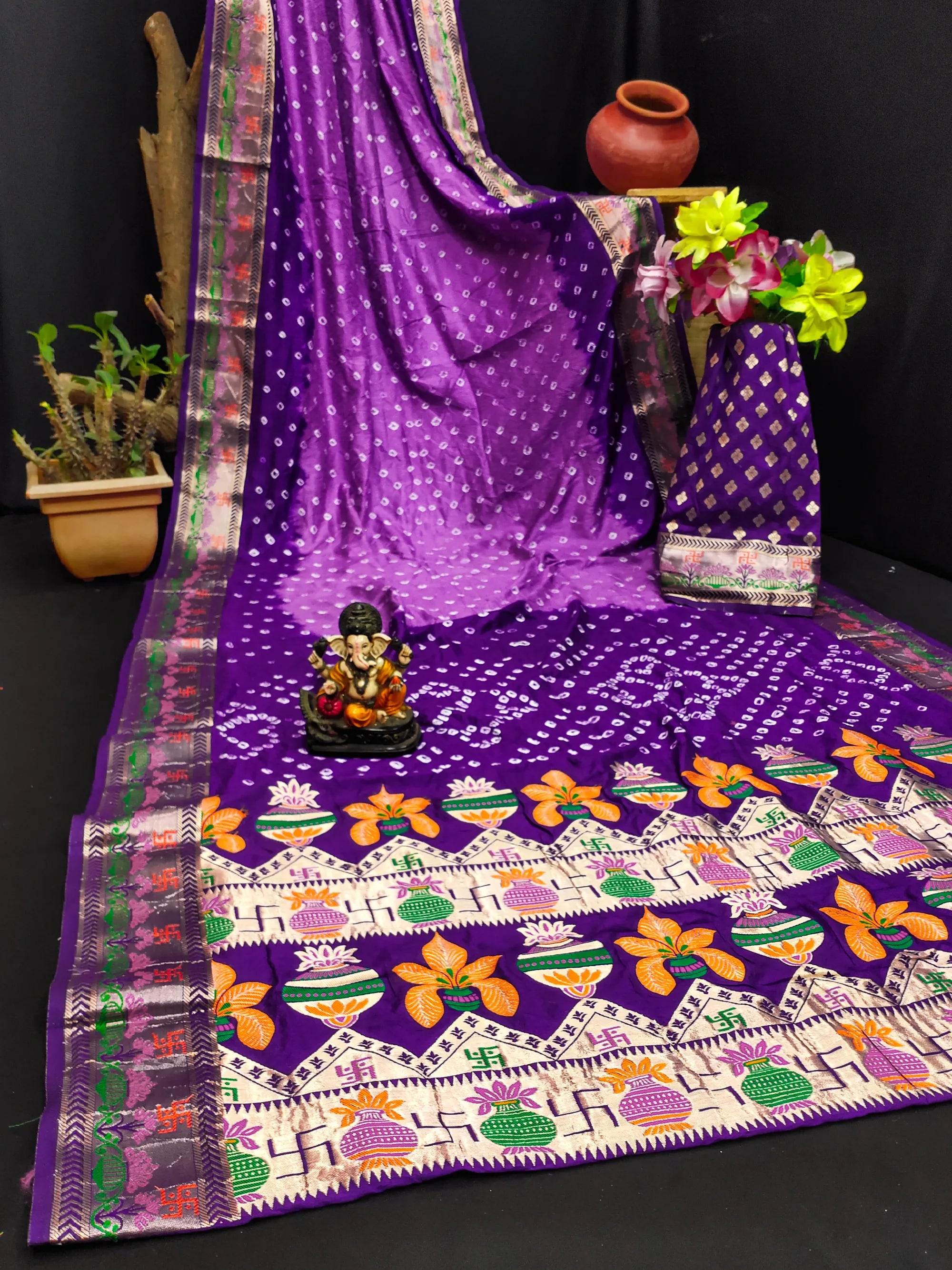 Purple saree with floral patterns on a black background