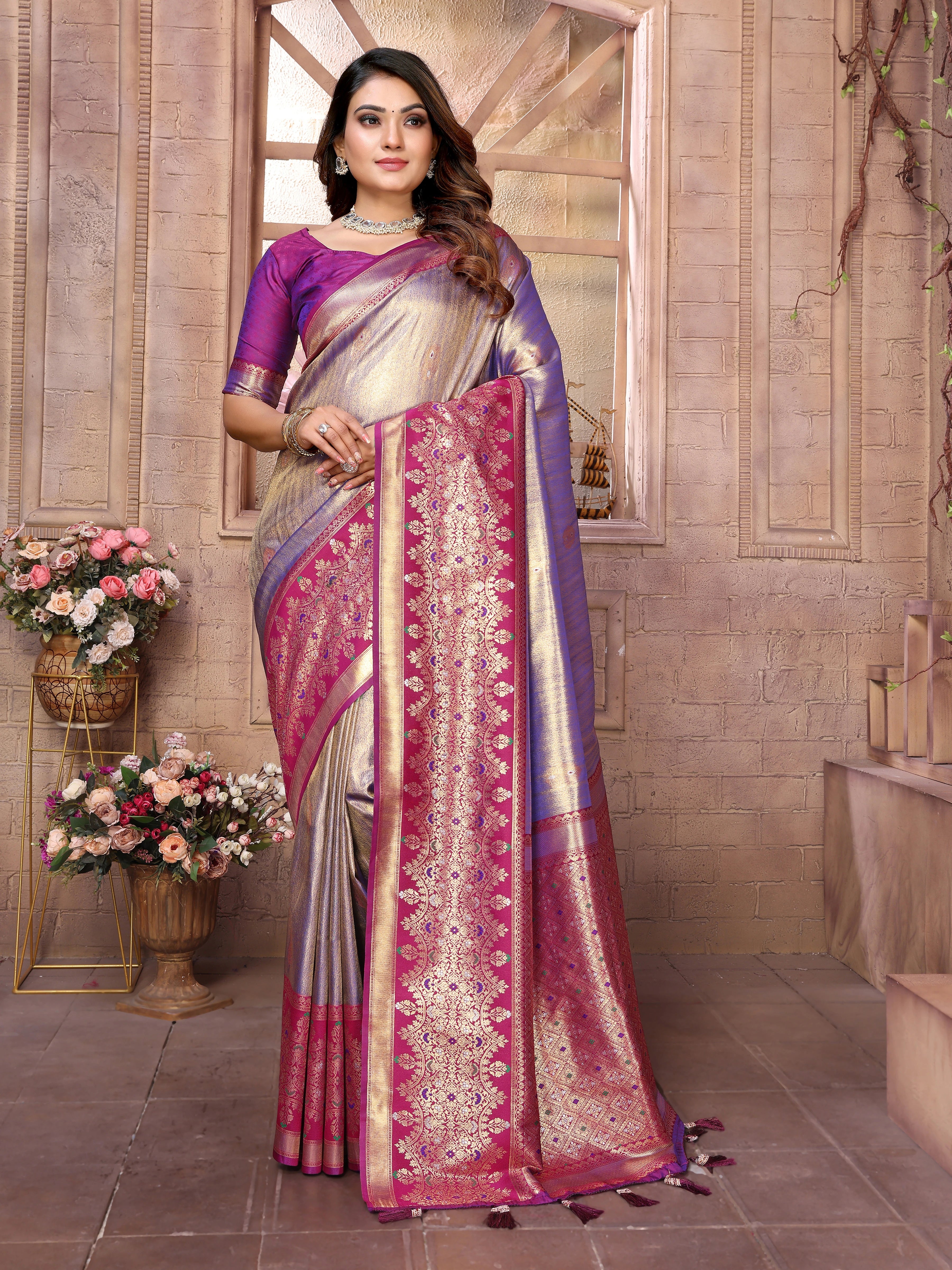 Woman wearing a traditional saree with floral decorations in the background