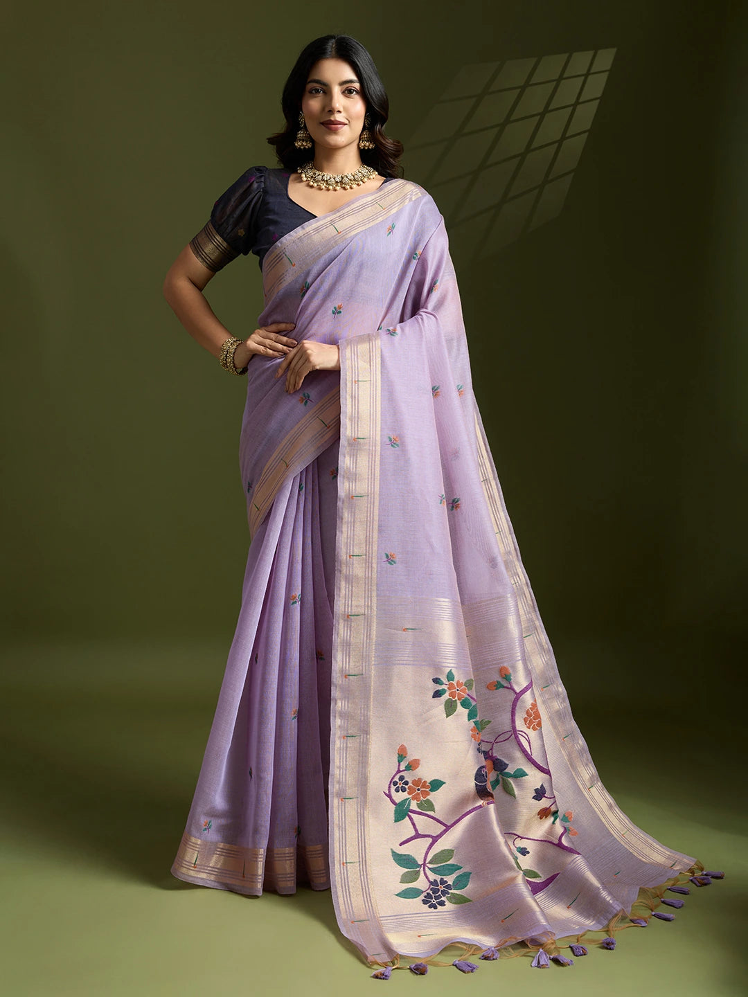 Woman wearing a lavender saree with a green background