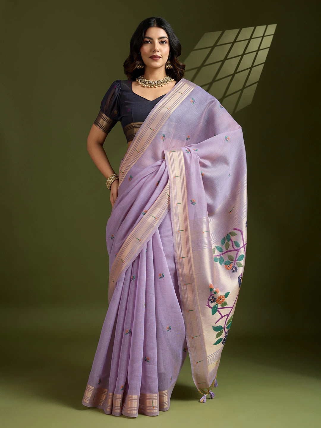 Woman wearing a lavender saree with a green background