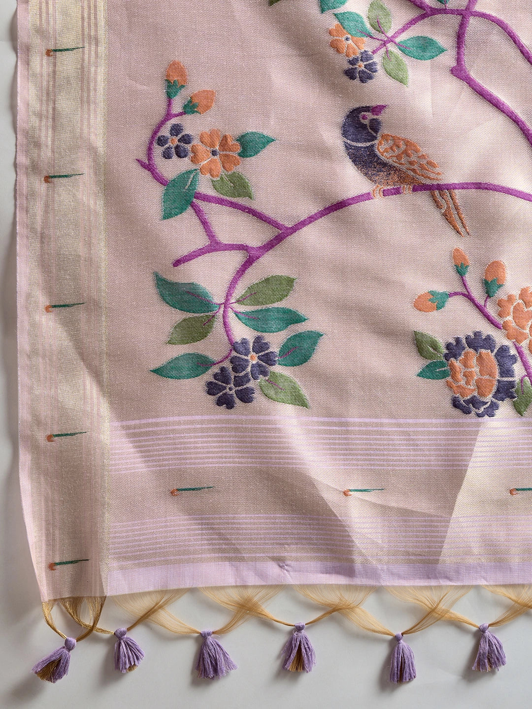 Embroidered fabric with floral and bird design on a beige background