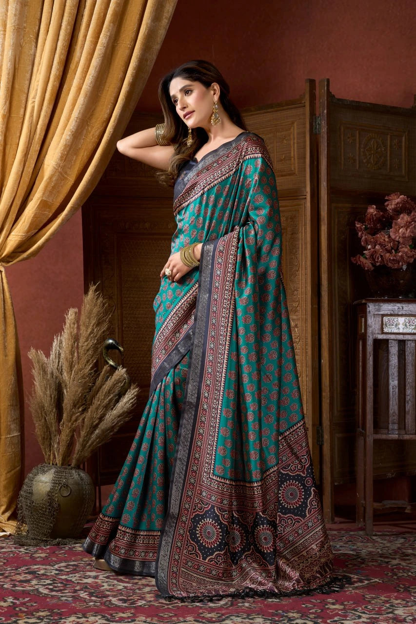 Woman in a traditional saree standing in a room with decorative elements.